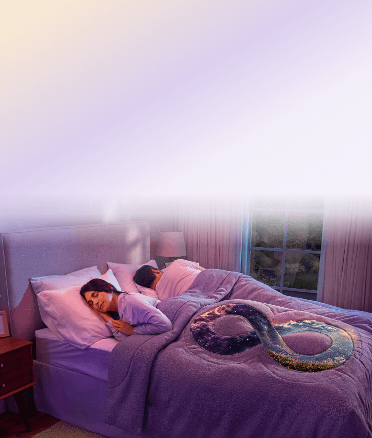 A woman sleeping in bed with an infinity symbol blanket